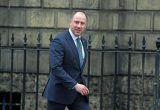 Neil Gray wearing a suit and arriving at Bute House, Edinburgh.